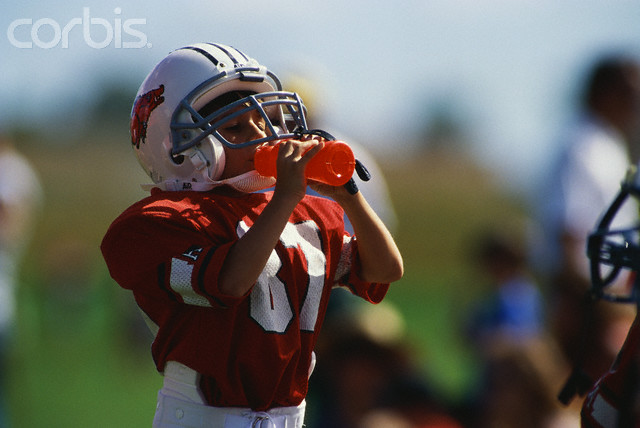 Youth Football Player Drinking Water
